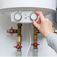 HVAC technician installing a smart thermostat on the wall.